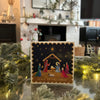 Nativity scene Christmas card, with a festive fireplace in the background