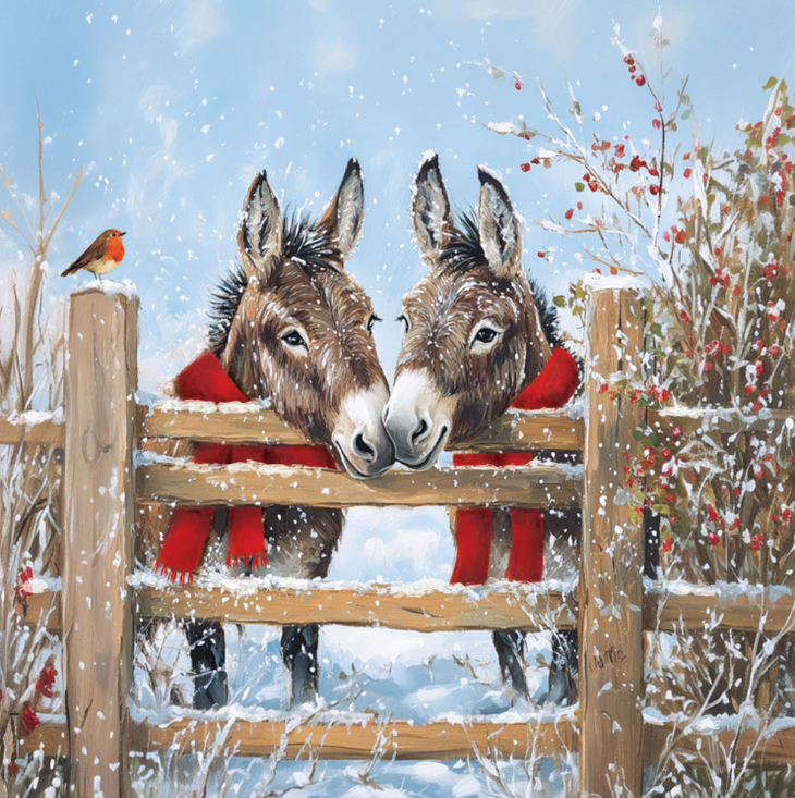 Two donkeys in red scarves standing behind a wooden fence in a snowy scene.