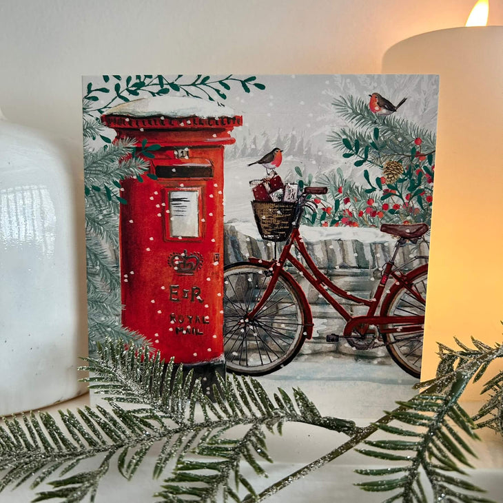 Snowy Postbox Christmas card on a mantlepiece