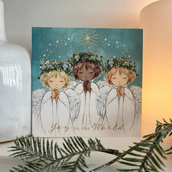 Angels Together Christmas card on a mantlepiece