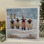 Sheeps with scarves and hats in snowy a field 