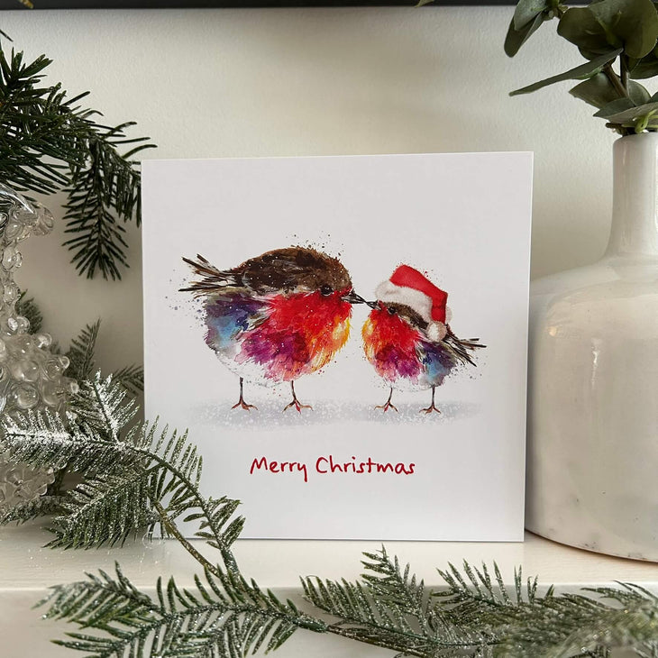 Fluffy robins Christmas card on mantlpiece