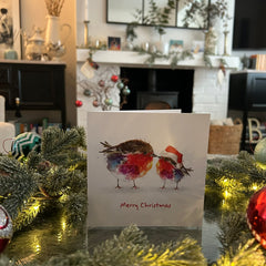 Fluffy Robins Christmas card with a festive fireplace in the background