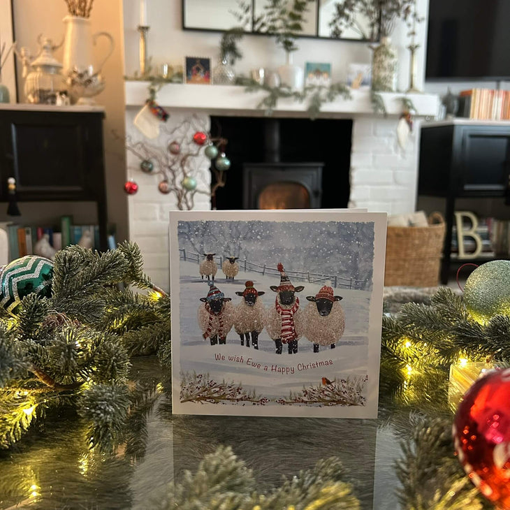 Sheeps with scarves and hats in snowy a field