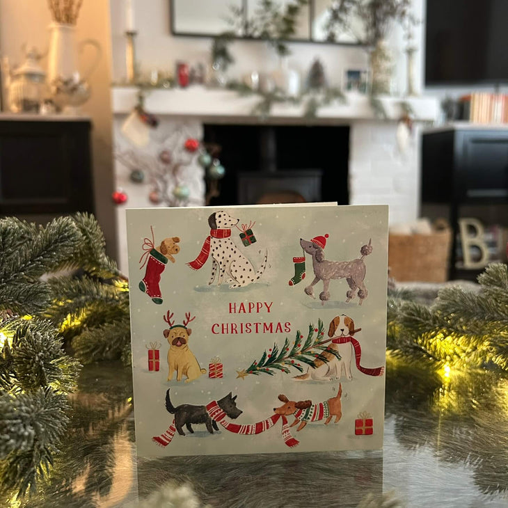 Festive Dogs Christmas card, with a festive fireplace in the background