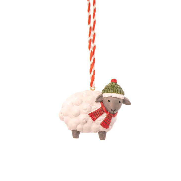 1 sheep decoration with a green woolly hat and red scarf