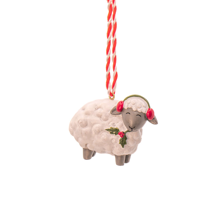 1 sheep decoration with red ear muffs and chewing a holly branch