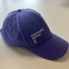 The front of our purple cap, with the Pancreatic Cancer UK logo in white